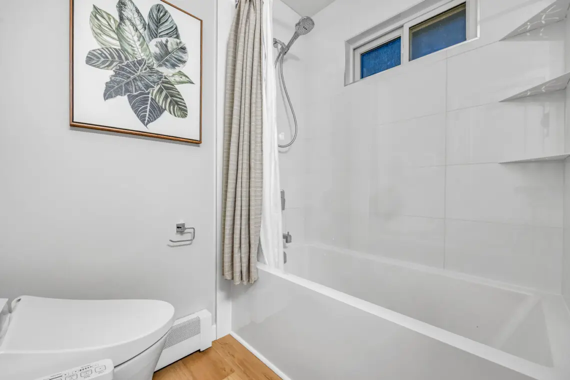 A cozy bathroom retreat where self-care meets serenity — complete with warm tones, soft lighting, and thoughtful modern touches that invite guests to unwind and enjoy a little everyday luxury during their stay.