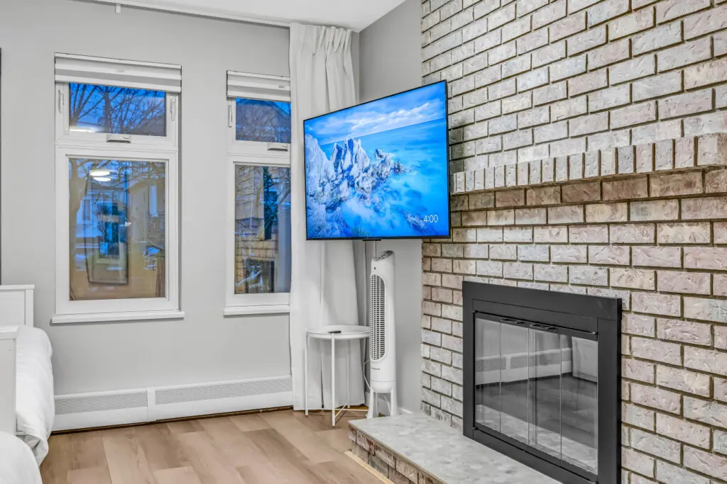 A bright and welcoming living area featuring a sleek fireplace and large windows that fill the space with natural light. Perfect for curling up with a good movie, relaxing after a day out, or simply soaking in the peaceful atmosphere.