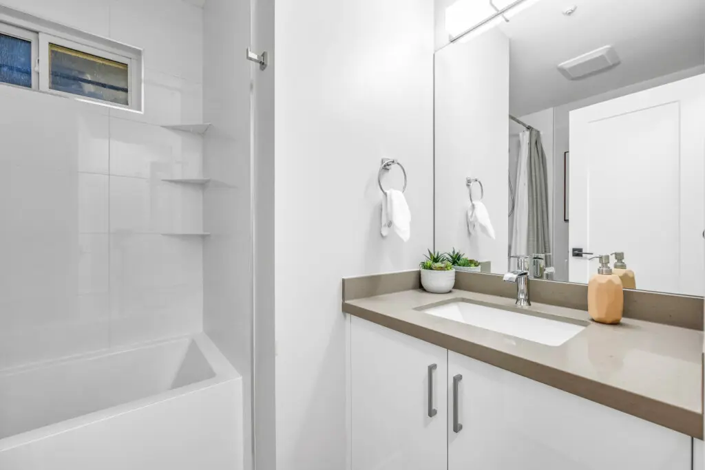 A bright, modern bathroom designed for both function and relaxation. Guests can unwind with a warm bath after a long day or refresh with ease in this clean, calming space.