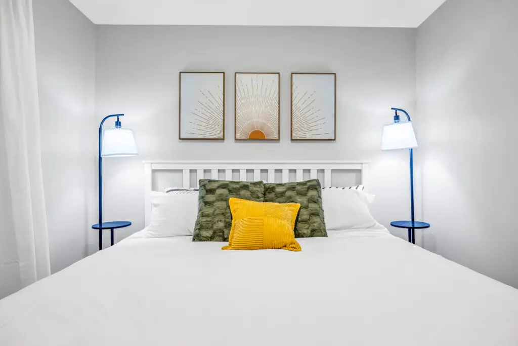 A bright and welcoming bedroom designed for relaxation, featuring a plush bed, soft textures, and calming décor. Thoughtful details and warm tones create a cozy, restful haven that instantly feels like home.