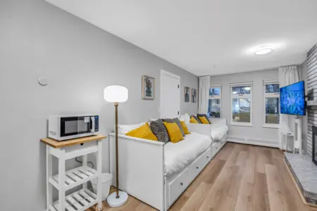 A bright and welcoming living space where comfort meets calm. With soft blankets, warm lighting, and cozy daybeds, it’s the perfect spot to relax and recharge after a busy day exploring the city.