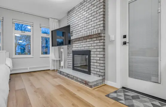 A welcoming living space where comfort meets calm — featuring a modern fireplace, warm wood floors, and soft natural light. Perfect for quiet mornings, movie nights, or simply unwinding after a day of exploring Vancouver.