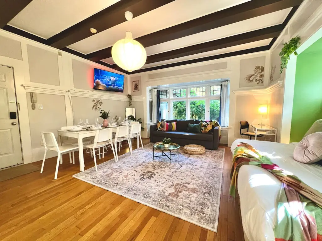 An open-concept living space filled with light and character — perfect for relaxing, dining, or watching a movie after exploring Vancouver. A stylish blend of comfort and charm throughout.
