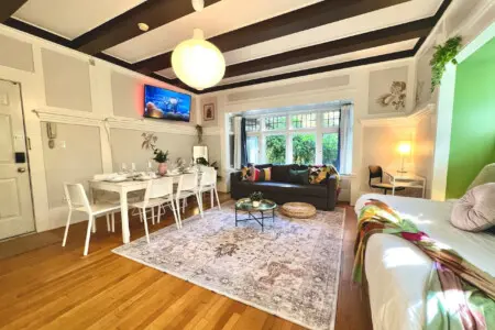 An open-concept living space filled with light and character — perfect for relaxing, dining, or watching a movie after exploring Vancouver. A stylish blend of comfort and charm throughout.