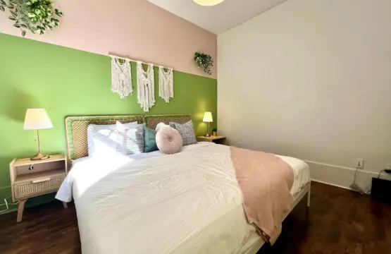 Soft colors and natural textures create a serene, modern bedroom retreat. Perfect for restful nights and peaceful mornings during your Vancouver getaway.