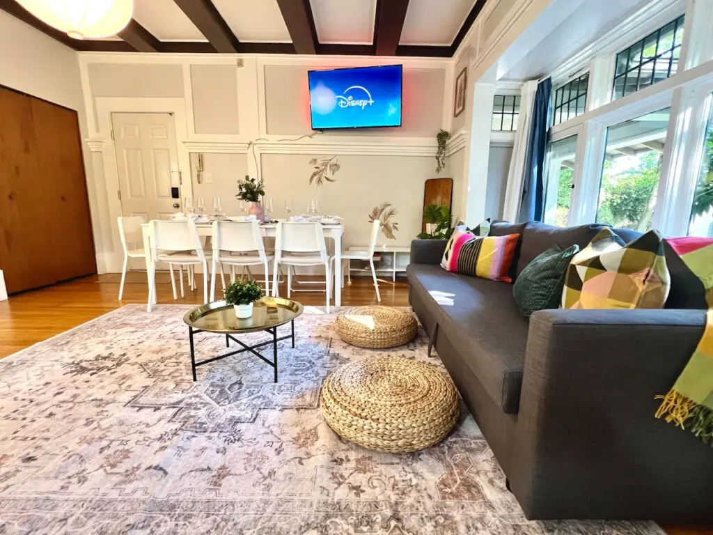 A bright, open living area designed for connection and comfort. Guests can unwind on the cozy sofa, stream their favorite shows, or gather for shared meals in this welcoming Vancouver retreat.