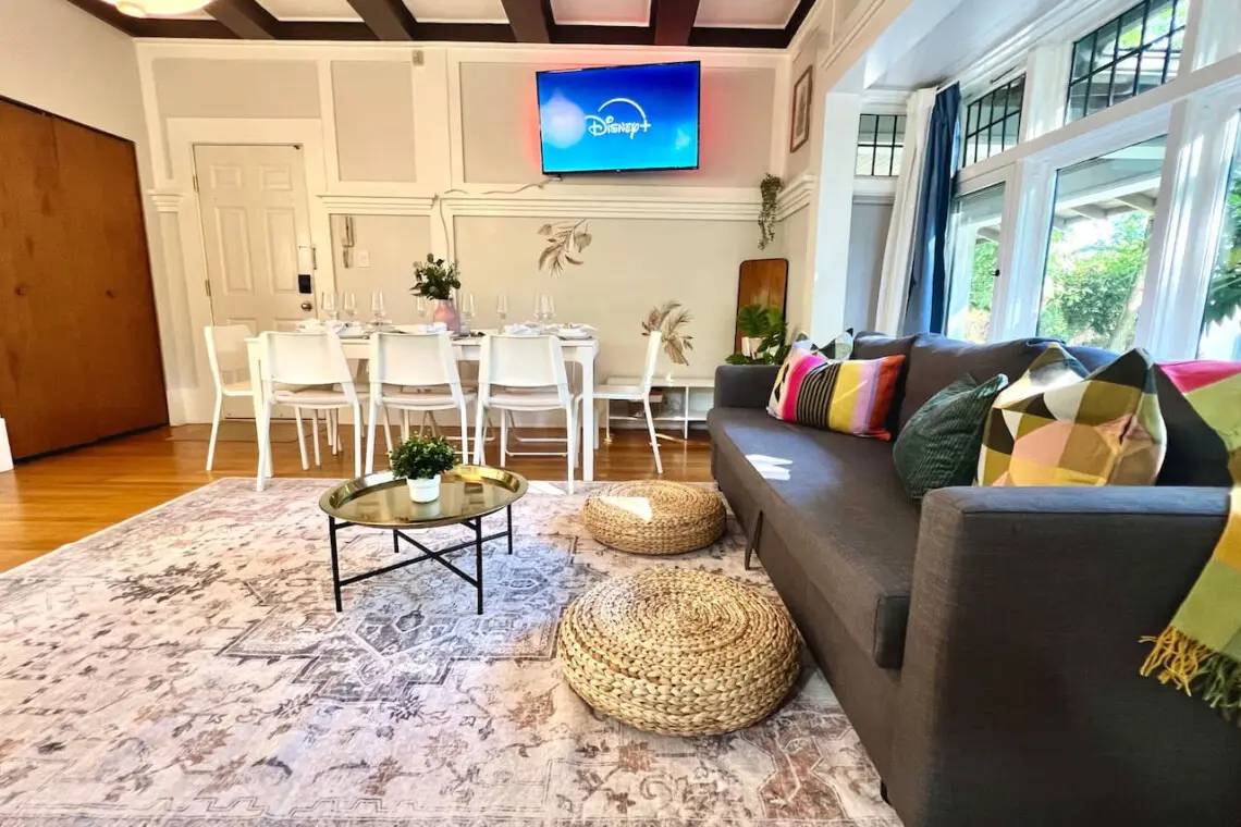 A bright, open living area designed for connection and comfort. Guests can unwind on the cozy sofa, stream their favorite shows, or gather for shared meals in this welcoming Vancouver retreat.