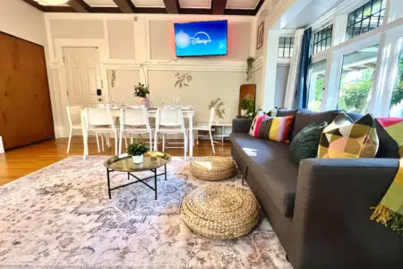 A bright, open living area designed for connection and comfort. Guests can unwind on the cozy sofa, stream their favorite shows, or gather for shared meals in this welcoming Vancouver retreat.