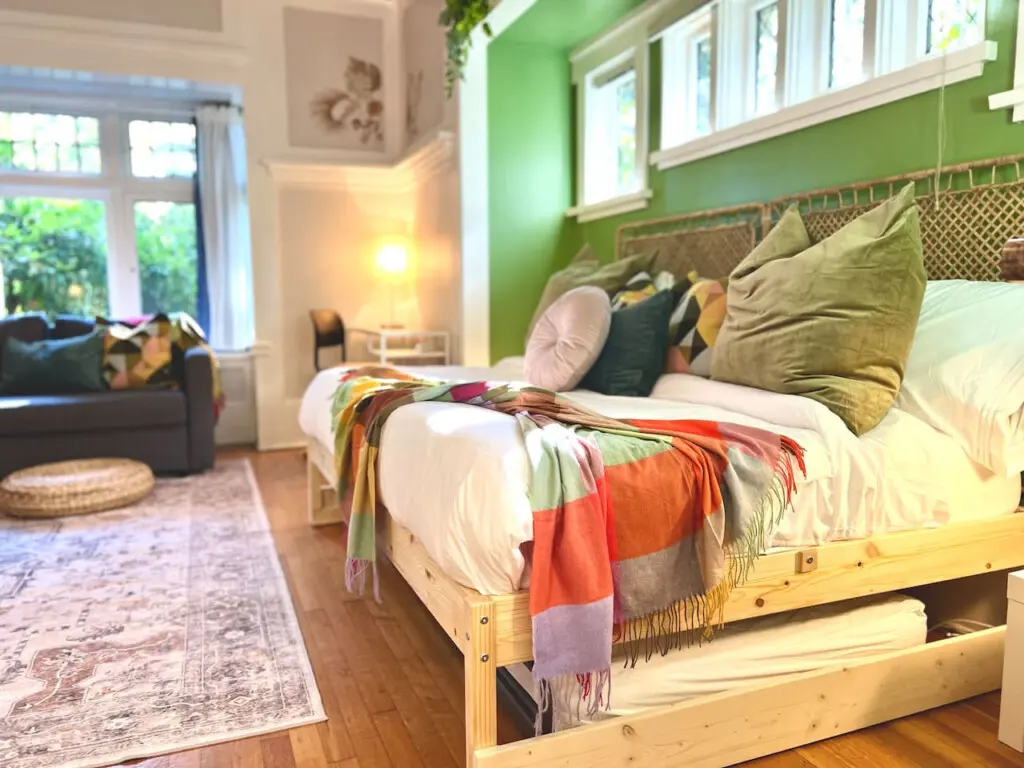 Soft light and vibrant accents make this cozy bedroom a serene retreat. Designed for comfort and style, it’s an inviting space to unwind during your Vancouver stay.