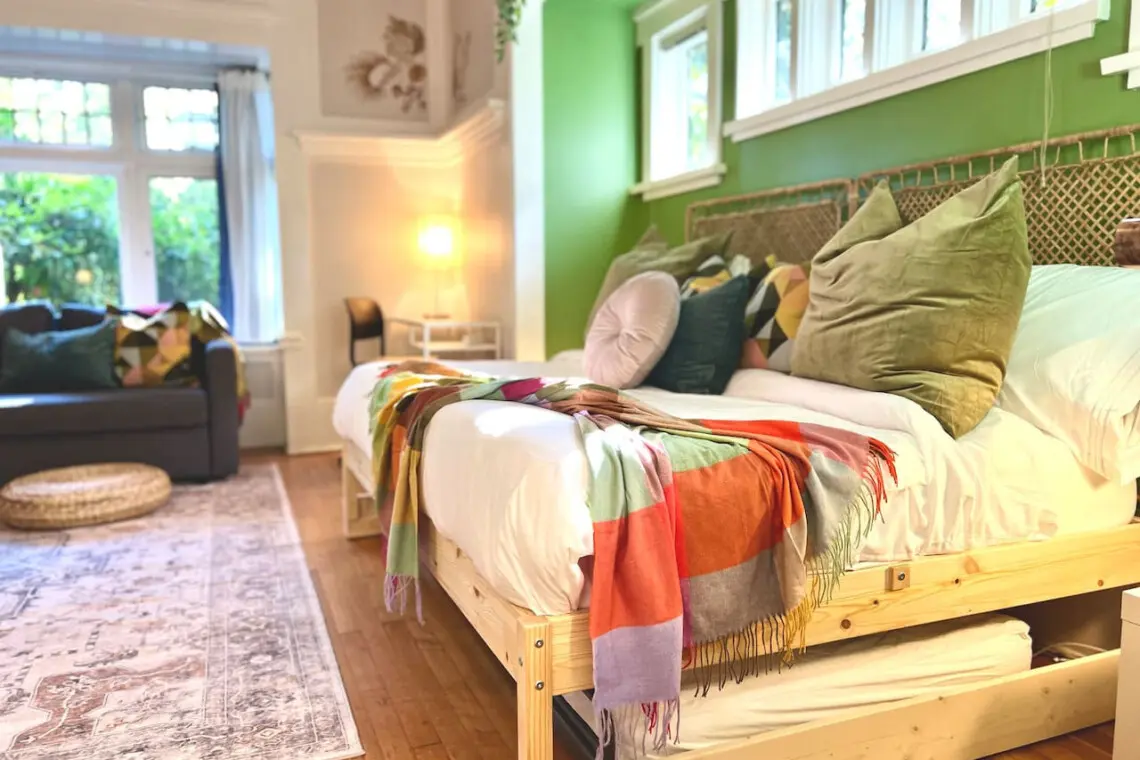 Soft light and vibrant accents make this cozy bedroom a serene retreat. Designed for comfort and style, it’s an inviting space to unwind during your Vancouver stay.