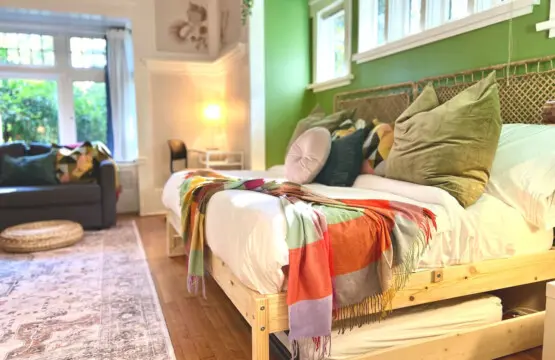 Soft light and vibrant accents make this cozy bedroom a serene retreat. Designed for comfort and style, it’s an inviting space to unwind during your Vancouver stay.