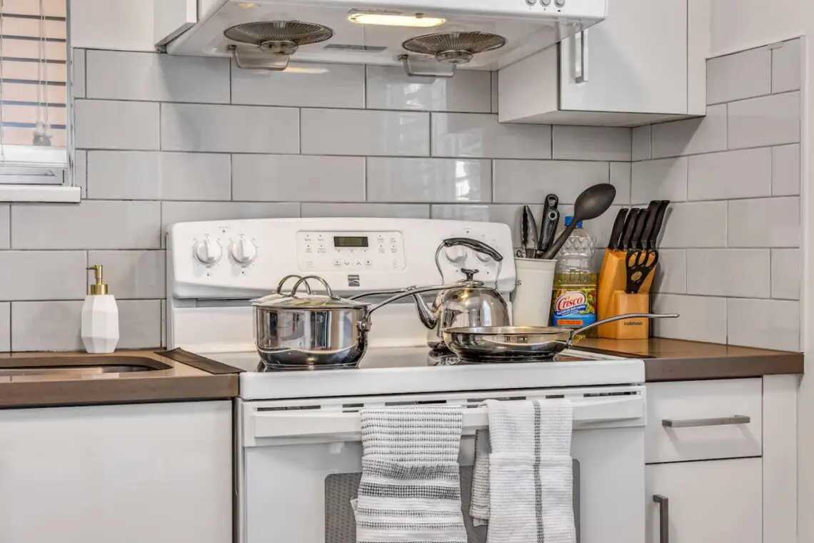 Prepare delicious home-cooked meals in this fully equipped kitchen, complete with modern cookware and essentials for a comfortable Vancouver stay.
