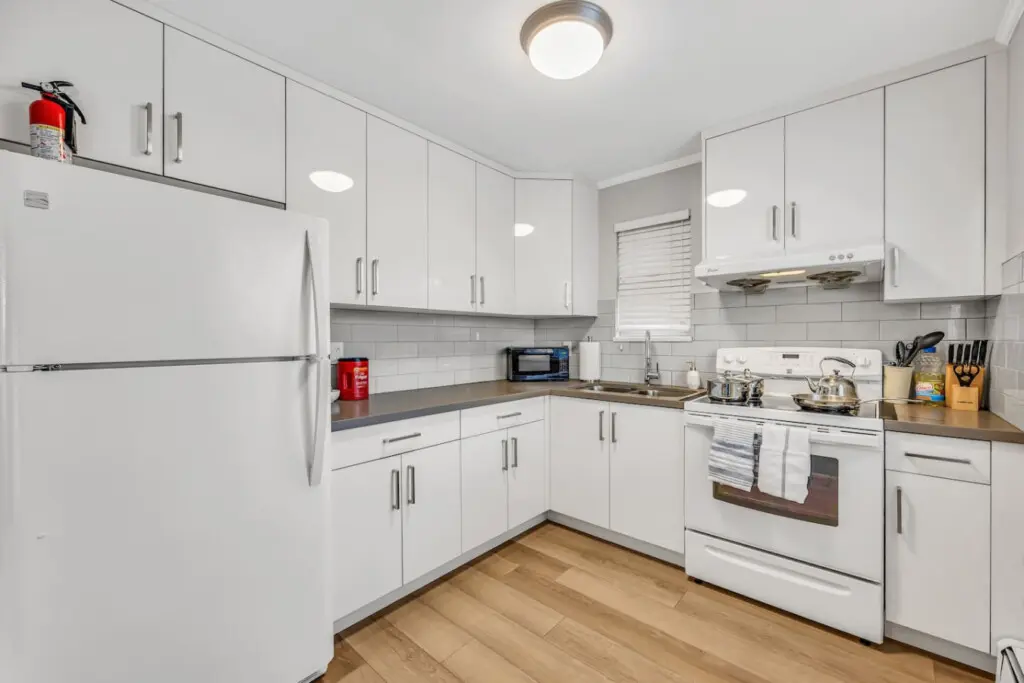 Enjoy home-cooked meals in this bright, well-appointed kitchen featuring modern appliances, ample counter space, and all the essentials for a comfortable and convenient stay.