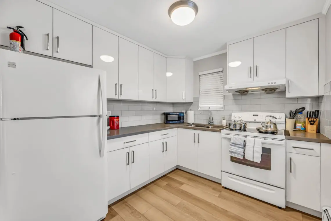 Enjoy home-cooked meals in this bright, well-appointed kitchen featuring modern appliances, ample counter space, and all the essentials for a comfortable and convenient stay.