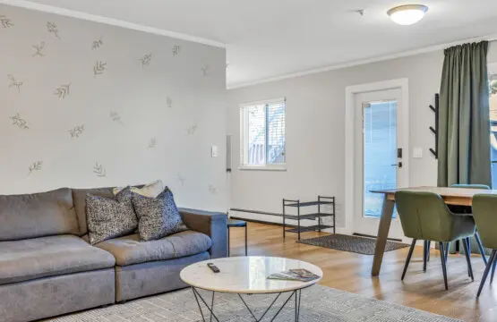 Modern living space featuring a cozy sofa, stylish décor, and a sleek dining area — perfect for relaxing, sharing meals, or enjoying quality time with family and friends.