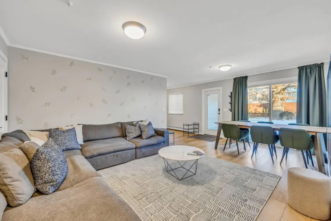 Spacious and inviting, this modern living room features plush couches perfect for relaxing after a full day of exploring Vancouver. A cozy spot to unwind, connect, and recharge.