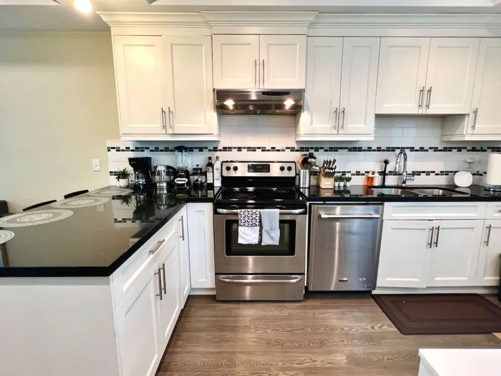This modern kitchen features a spacious countertop perfect for meal prep, casual dining, or gathering with friends — complete with stainless steel appliances and sleek finishes for a contemporary touch.