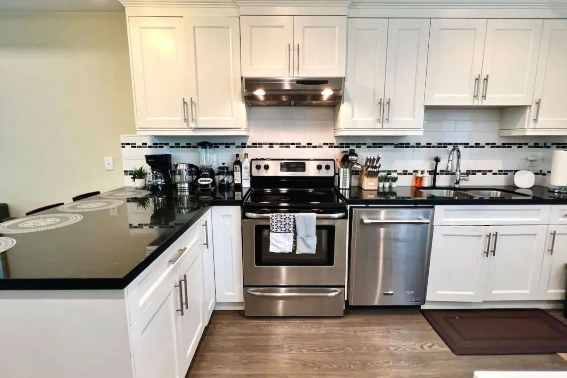 This modern kitchen features a spacious countertop perfect for meal prep, casual dining, or gathering with friends — complete with stainless steel appliances and sleek finishes for a contemporary touch.