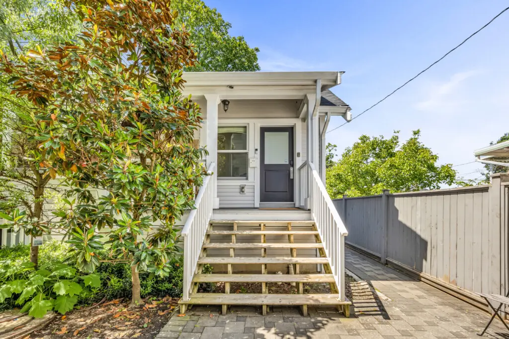 Welcoming front entry with charming steps and greenery, setting a peaceful tone as you arrive at your relaxing home retreat.