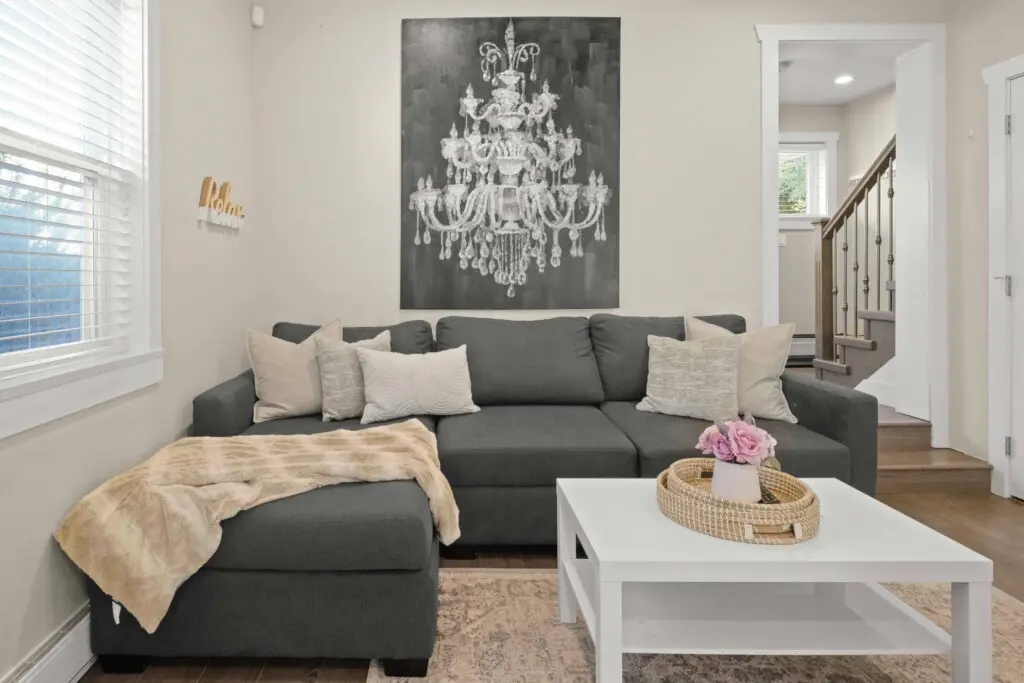 A cozy living space featuring a plush sectional that converts into a double bed — perfect for relaxing or hosting extra guests. Soft tones and natural light make this the ideal spot to unwind after a day in Vancouver.