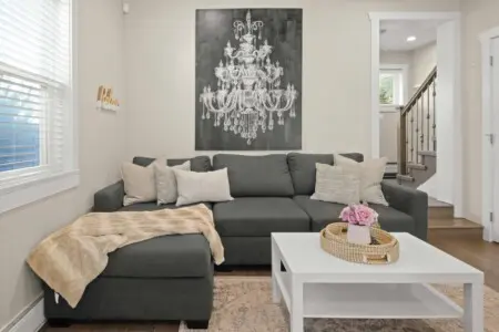 A cozy living space featuring a plush sectional that converts into a double bed — perfect for relaxing or hosting extra guests. Soft tones and natural light make this the ideal spot to unwind after a day in Vancouver.