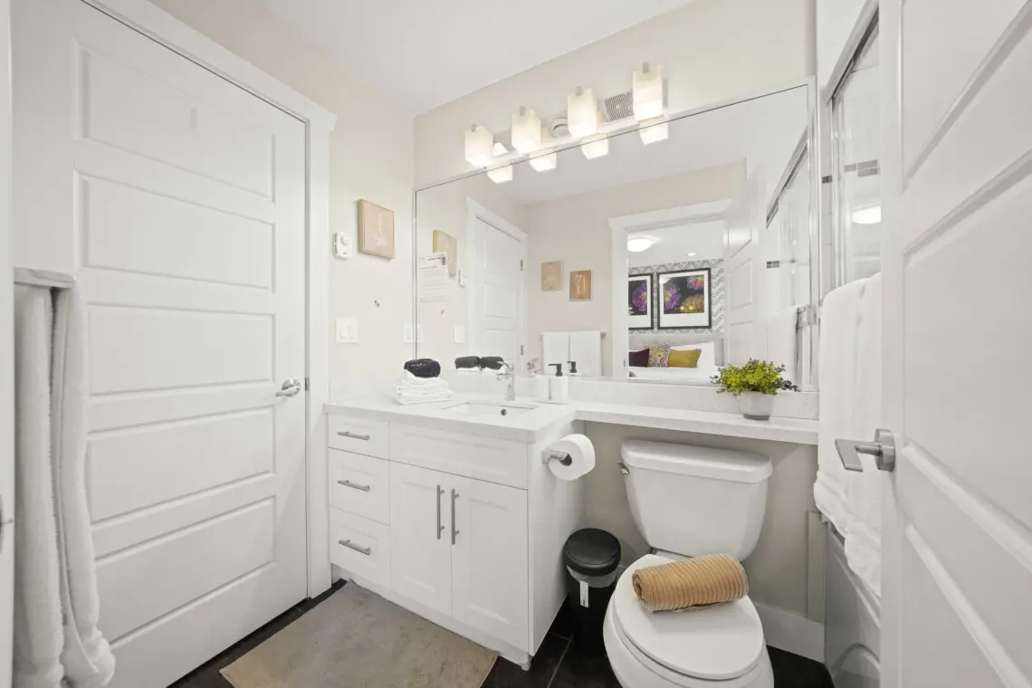 This bright upstairs bathroom beside the primary bedroom blends modern style with everyday comfort. With sleek fixtures, a wide mirror, and freshly folded towels, it’s a calm, refreshing space to unwind after a day in the city.
