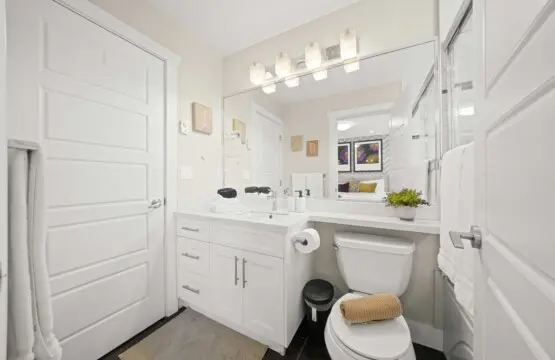 This bright upstairs bathroom beside the primary bedroom blends modern style with everyday comfort. With sleek fixtures, a wide mirror, and freshly folded towels, it’s a calm, refreshing space to unwind after a day in the city.