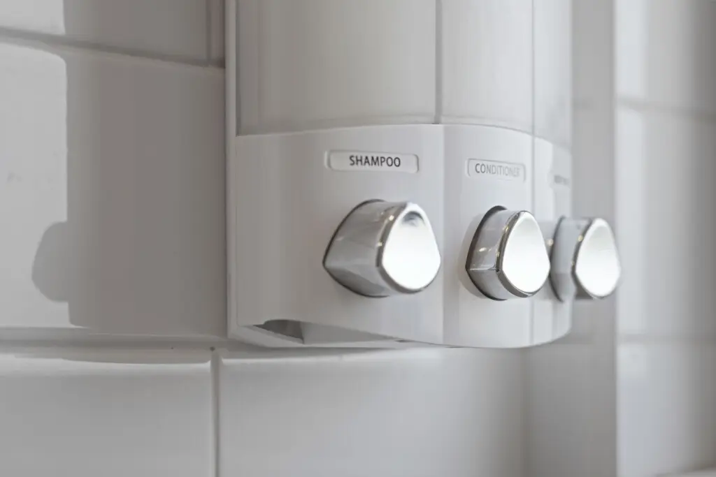 Each bathroom is stocked with premium shampoo, conditioner, and body wash in sleek, refillable dispensers — a modern touch that adds both convenience and sustainability to your stay.