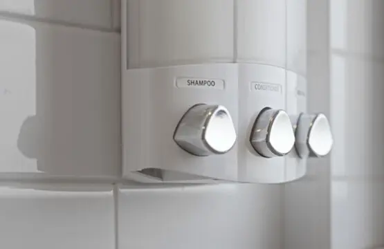 Each bathroom is stocked with premium shampoo, conditioner, and body wash in sleek, refillable dispensers — a modern touch that adds both convenience and sustainability to your stay.