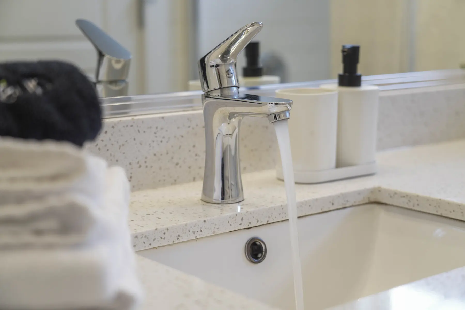 Located beside the primary bedroom, the second-floor bathroom offers a touch of everyday luxury with sleek chrome fixtures and a polished quartz countertop. Bright and spotless, it’s thoughtfully designed for a relaxing day.
