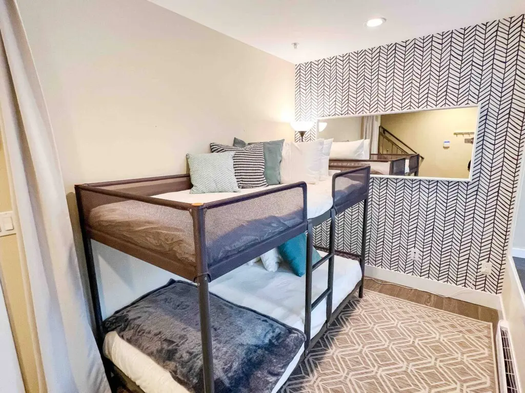 Located on the first floor, this cozy den features twin bunk beds and a calm, modern design. Soft textures and natural light create a peaceful space for rest or quiet relaxation.
