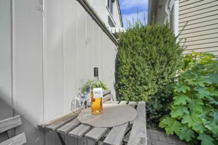 A quaint shared patio provides the perfect spot to enjoy a morning coffee or evening glass of wine surrounded by greenery. This charming outdoor nook adds a touch of relaxation and fresh air to your Vancouver stay.