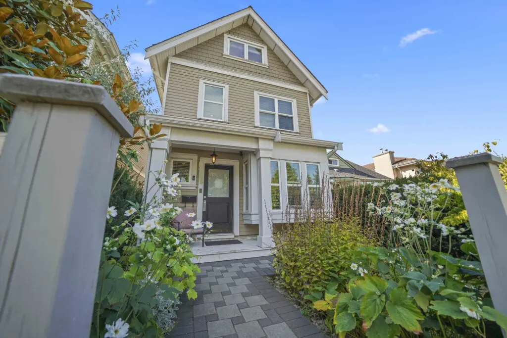 Welcome to your Vancouver retreat — a charming townhouse surrounded by lush greenery and blooming garden paths. The inviting entrance sets the tone for a stay filled with comfort, style, and West Coast charm.