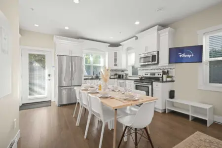 This bright open-concept kitchen and dining area offers a welcoming space for shared meals and connection. With seating for eight and modern finishes throughout, it’s perfect for family dinners or relaxed evenings in.