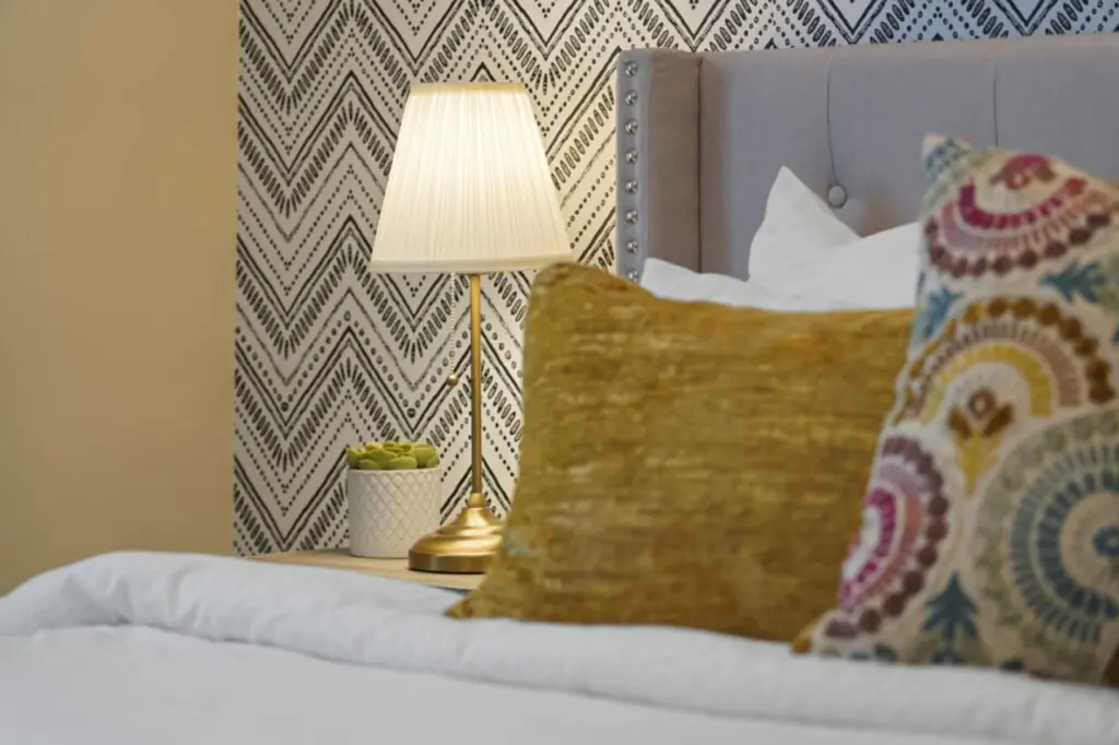 Elegant details bring warmth and charm to the primary bedroom, from the soft bedding and textured pillows to the gentle glow of the bedside lamp. Thoughtfully designed, it offers a cozy and refined space to unwind and recharge.