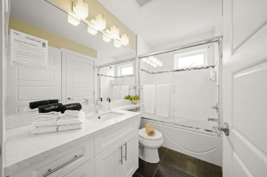 This bright upstairs bathroom beside the primary bedroom blends modern style with everyday comfort. With sleek fixtures, a wide mirror, and freshly folded towels, it’s a calm, refreshing space to unwind after a day in the city.