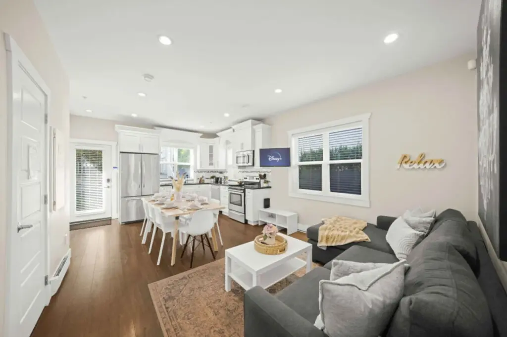 Bright & Welcoming — this open-concept living and dining area offers the perfect setting for connection and comfort. With seating for up to ten, guests can enjoy shared meals, movie nights, or relaxing downtime in true Vancouver style.
