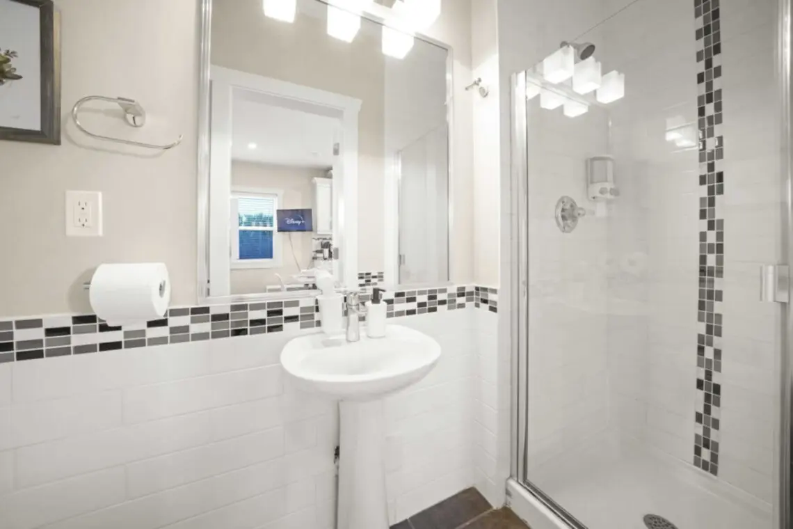 The main floor bathroom offers a sleek, modern design with a bright walk-in shower and contemporary finishes. Conveniently located on the first floor, it provides easy access and a refreshing start or end to the day during your Vancouver stay.