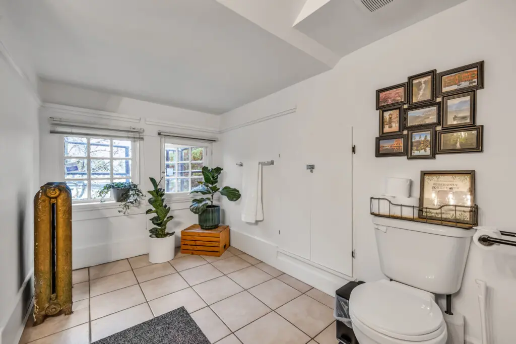 A bright, airy bathroom featuring thoughtful décor, cozy plants, and a convenient setup for your comfort and relaxation.