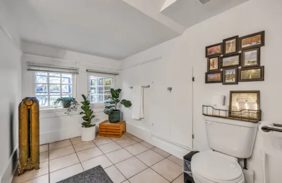 A bright, airy bathroom featuring thoughtful décor, cozy plants, and a convenient setup for your comfort and relaxation.