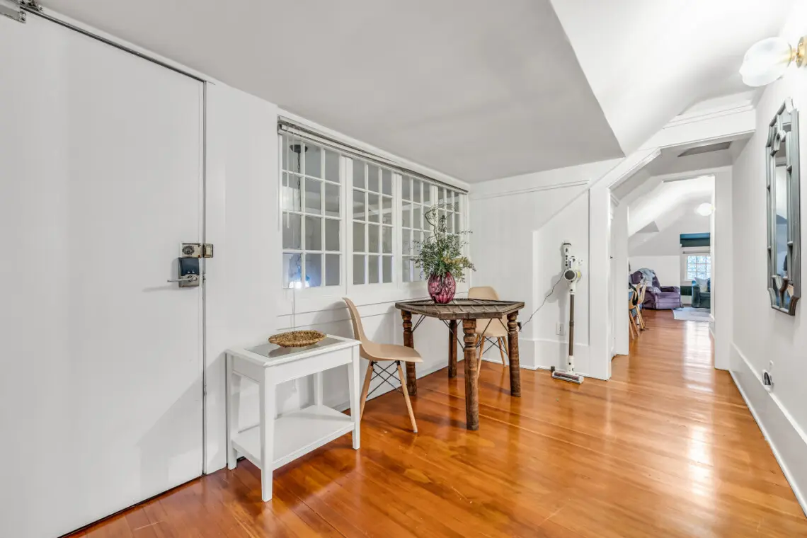 A cozy corner with a charming table, two chairs, and a decorative vase, offering a peaceful spot to enjoy your morning coffee or work in comfort.