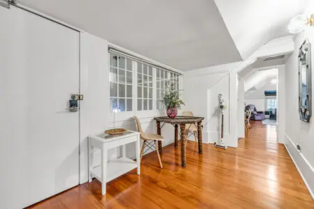 A cozy corner with a charming table, two chairs, and a decorative vase, offering a peaceful spot to enjoy your morning coffee or work in comfort.