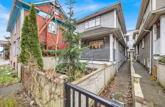 Charming exterior view showcasing a quaint house with a front porch, surrounded by greenery and an inviting walkway leading to the entrance.