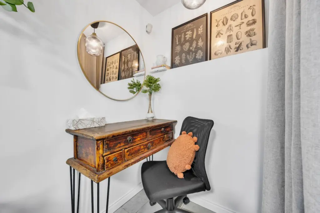 Charming workspace with a vintage desk, cozy chair, and stylish decor, creating a serene corner for productivity or relaxation.