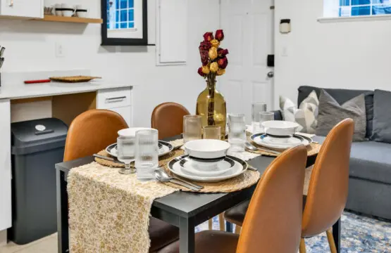 Stylish dining area with a modern table set for four, complemented by cozy seating and elegant décor, perfect for enjoying meals together.