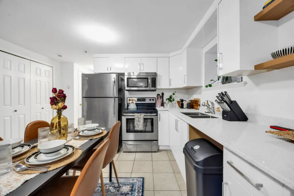 Modern kitchen with sleek stainless steel appliances, stylish open shelving, and ample counter space, perfect for meal preparation and entertaining.