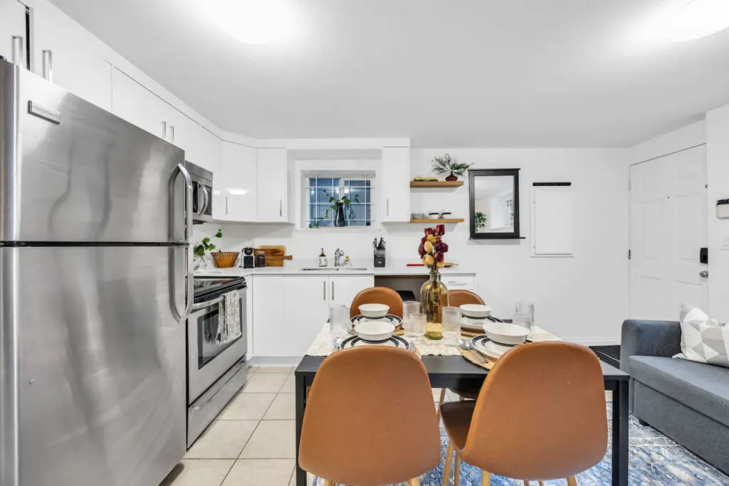 Bright, functional kitchen with modern appliances and a welcoming dining area, perfect for preparing and enjoying meals in a stylish setting.