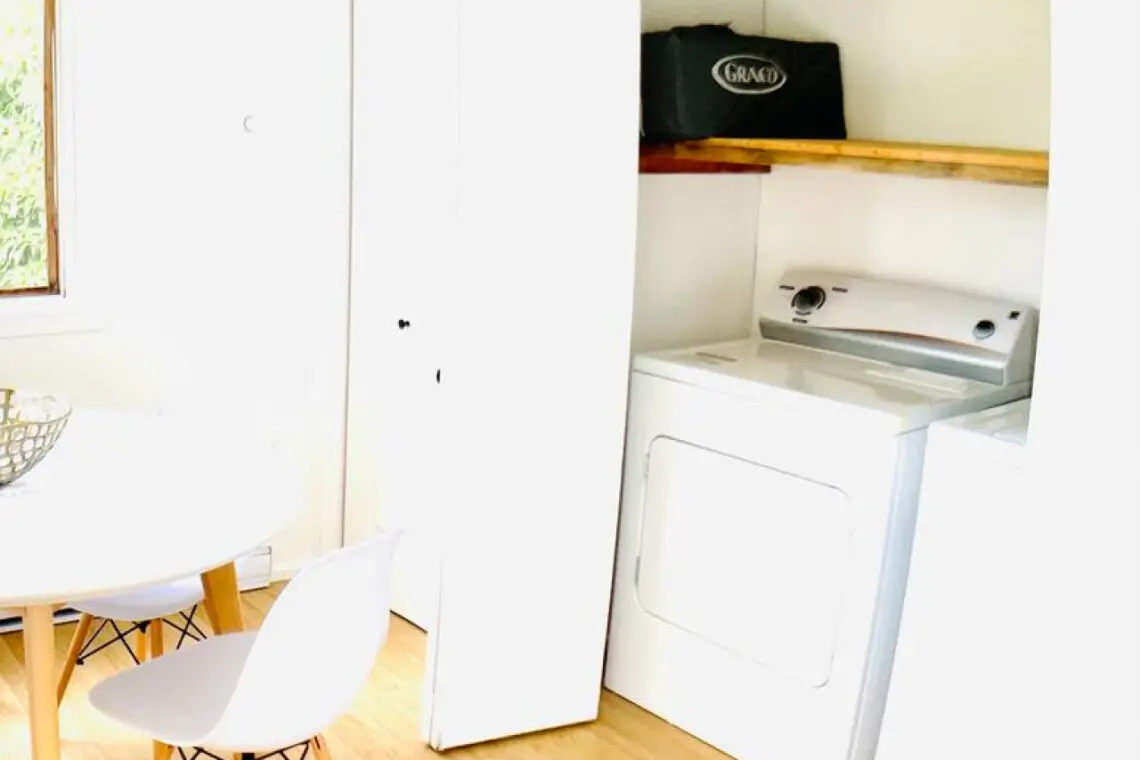 Convenient laundry nook with modern washer and dryer, offering a practical and space-efficient solution for your stay.