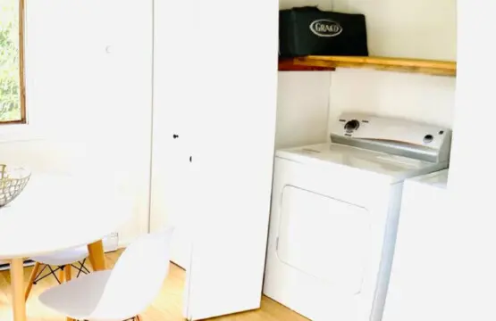 Convenient laundry nook with modern washer and dryer, offering a practical and space-efficient solution for your stay.