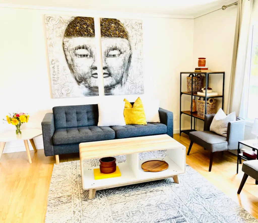 Inviting living room featuring a comfortable sofa, stylish accent chairs, and serene artwork, creating a calming atmosphere perfect for relaxation.